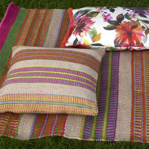 Designers Guild Mahakam Fuchsia Outdoor Cushion on Coordinating Outdoor Rug