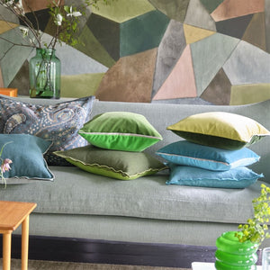 Varese Lime & Fir Cushion, by Designers Guild shown with other throw cushions