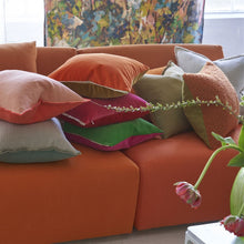 Load image into Gallery viewer, Varese Zinnia &amp; Ochre Cushion, by Designers Guild with other throw cushions on sofa
