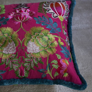 Designers Guild Brocart Décoratif Embroidered Cerise Cushion on light coloured area rug