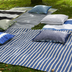 Designers Guild Pompano Indigo Outdoor Cushion on Outdoor Rug