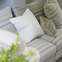 Indlæs billede til gallerivisning Striped sofa with patterned and solid color cushions in a living room setting.