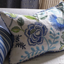 Load image into Gallery viewer, Floral embroidered pillow on a couch with striped cushions.