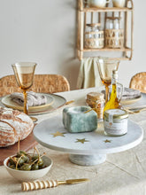 Load image into Gallery viewer, white marble cake stand with 3 brass stars imbedded on dining table