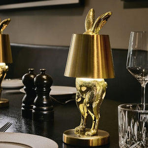 Portable LED Hiding Bunny Table Lamp, Gold lit on Black Dining Table