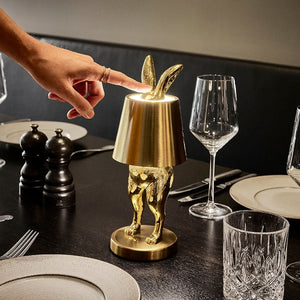 Portable LED Hiding Bunny Table Lamp, Gold on Black Dining Table