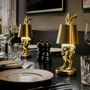 Two LED Hiding Bunny Table Lamps in Gold on Dining Table